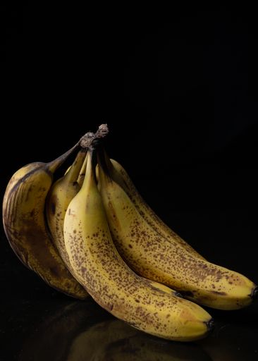 A shot of bananas in a group on isolated black background