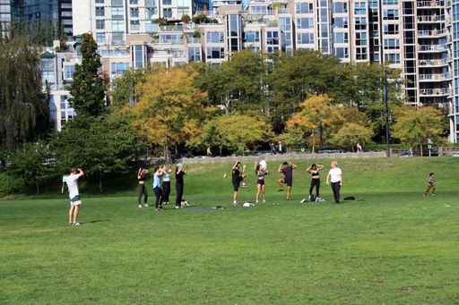 A group of people exercising in a park in downtown Vancouver, British Columbia, Canada