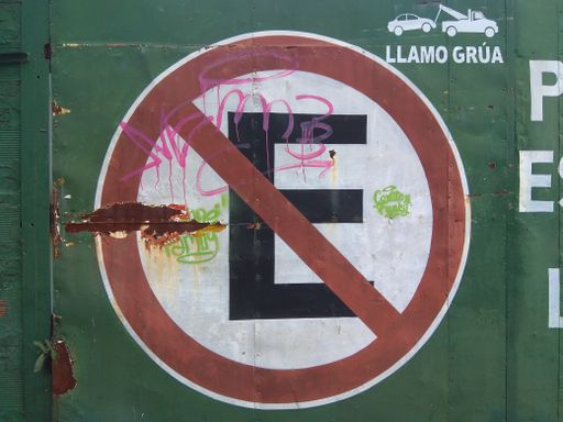 A traffic sign "E" painted on a green wall