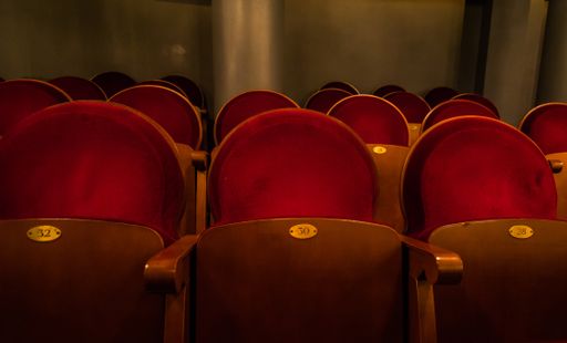 A closeup shot of empty red concert seats during pandemic