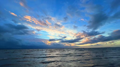 A beautiful shot of massive clouds over a beautiful sea during the sunset