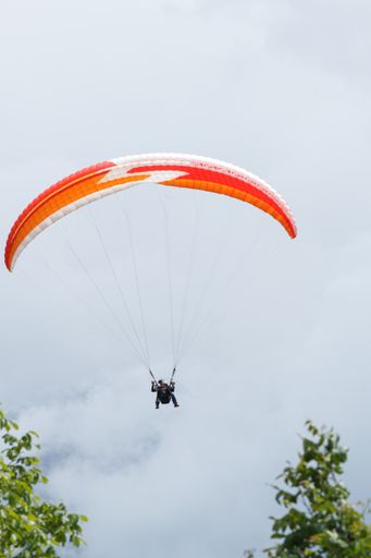A vertical shot of tandem paragliders in Interlaken, Switzerland