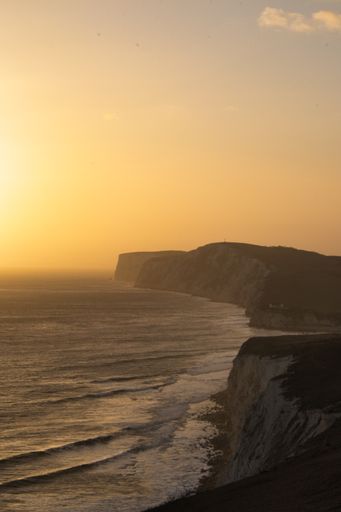 A vertical shot of a beautiful seascape at scenic sunset