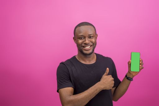 A young black male holding his smartphone with a blank screen