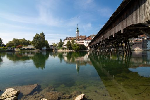 A beautiful landscape of a bridge crossing the river and a church in the back in Olten, Switzerland