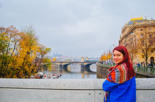 A young attractive female on the Charles Bridge background in Prague, Czechia