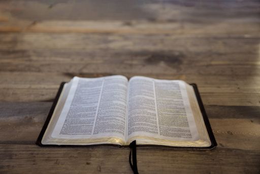 A high angle shot of an open book on a wooden surface