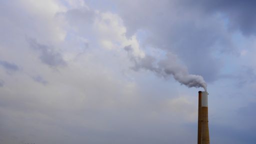 An industrial chimney with gases and smoke coming out - concept: air pollution