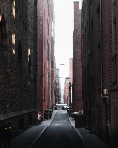 A narrow street between residential buildings in Boston
