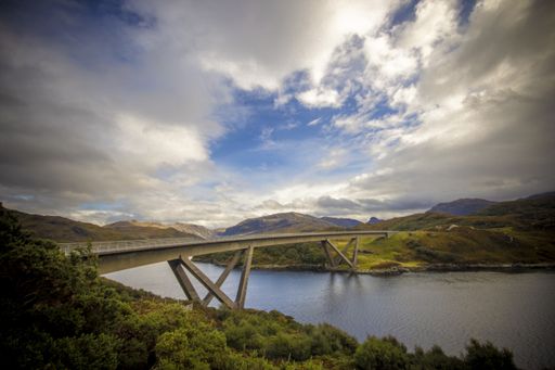 A view of Kylesku Bridge in United Kingdom under a cloudy blue sky