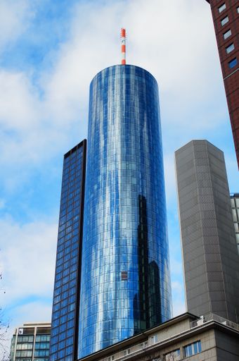 The MAIN TOWER in Frankfurt reflects the cloudy blue evening sky in Frankfurt. The main tenant is Landesbank Hessen-Thueringen (Helaba).