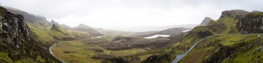 A panoramic shot of Quiraing in the Isle of Skye in Scotland with a cloudy sky in the background
