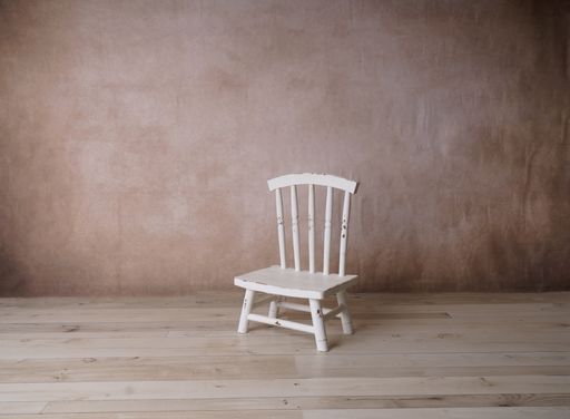 A closeup of a white chair in a room
