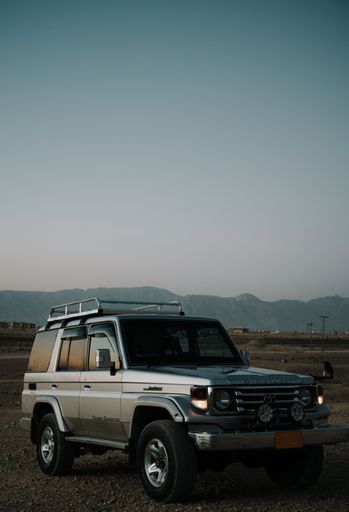 A vertical shot of a toyota land cruiser desertscape in the evening