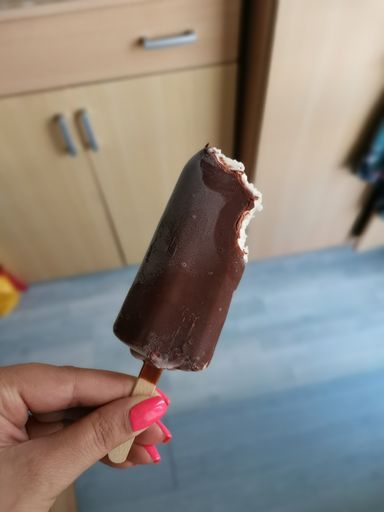 A closeup shot of an ice cream covered with chocolate