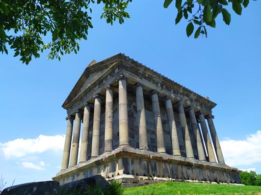 A low angle shot of the  Garni Temple against blue sky in bright sunlight in Garni, Kotayk Province, Armenia