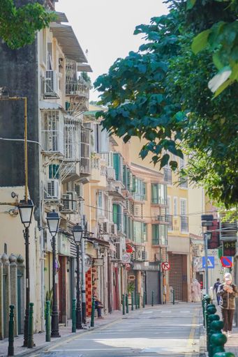 A vertical shot of a street with different buildings in Macau, China