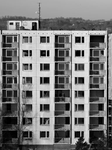 A black and white shot of an abandoned panel building in the Czech Republic