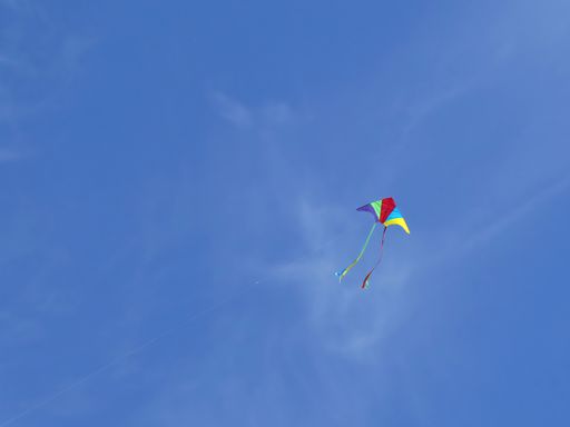 A closeup shot of a colorful kite floating in the sky