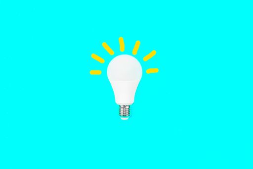 A switched on light bulb on a light blue background - a symbol of a new idea, innovation