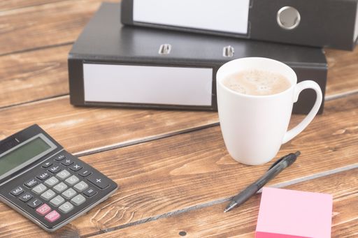 An angle shot of some accounting objects on a wooden table with copy space.