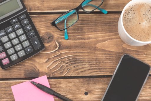 A top shot of some accounting objects on a wooden table with copy space.