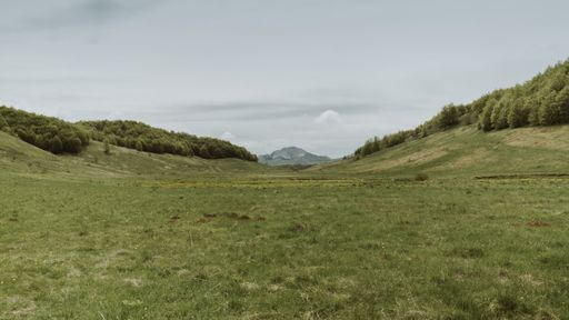The Bjelasnica mountain view in the distance from green valley