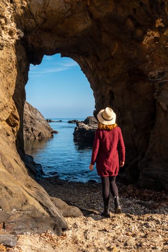 A young tourist girl with a hat in the Almanzora caves in Spain during summertime