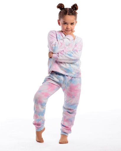 A portrait of a little girl in sportswear doing gymnastics in photo studio on white background