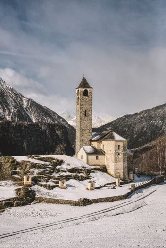 A vertical shot of a church in Rossura in Switzerland during a winter day