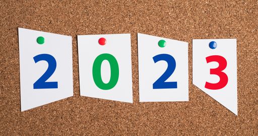 The new year 2023 is standing on white paper pinned to a corkboard