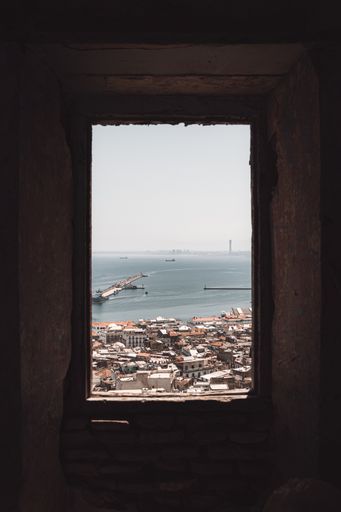 A beautiful shot of Casbah the citadel of Algiers as it's seeing from an old brick window on a sunny day, Algeria