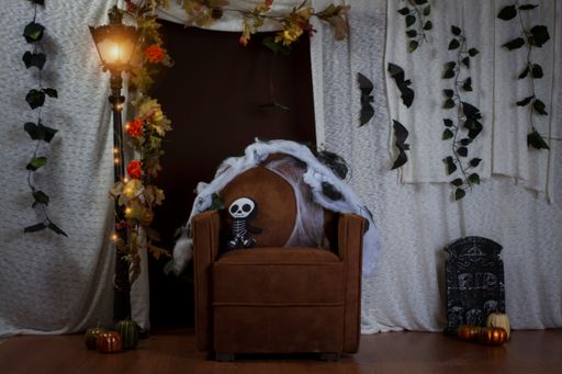 A closeup of a spooky bear sitting on an armchair in a room
