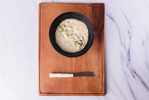 A high angle shot of a bowl of some healthy homemade food on a wooden surface