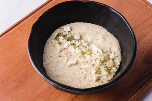 A high angle shot of a bowl of some healthy homemade food on a wooden surface