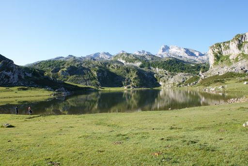 photo of small pond surrounded with hills and mountain valley