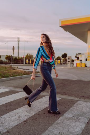 A closeup of an attractive woman posing for the camera at gas station