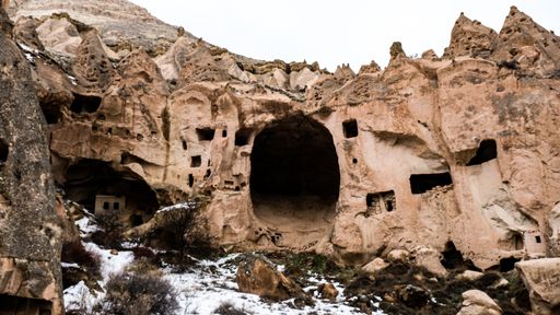 A low angle shot of stone formations and fairy chimneys in Cappadocia, Turkey