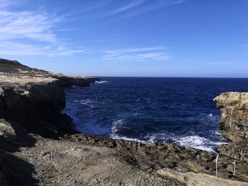 A beautiful view of rocky seashore under a cloudy sky
