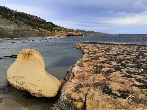 A beautiful view of rocky seashore under a cloudy sky