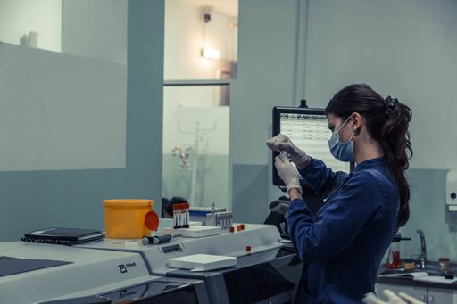 A young female scientist with a mask working in a medical laboratory