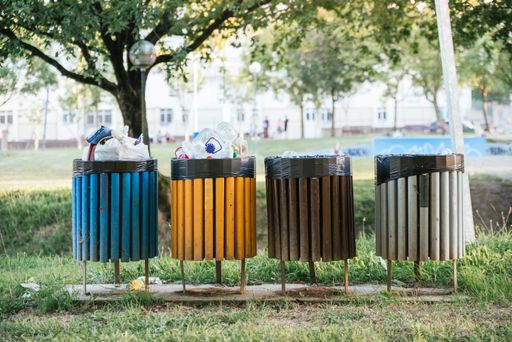 A landscape shot of colorful garbage bins outside promoting clean environment