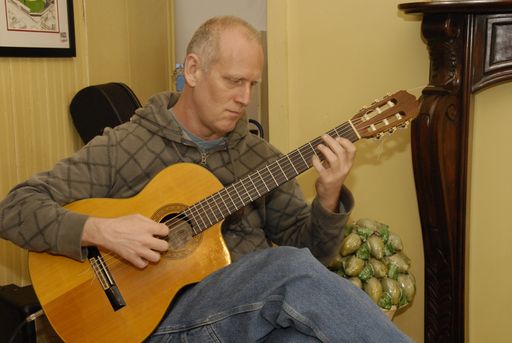 a guitar player performing at a coffee shop in Missouri