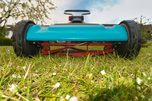 A closeup shot of a blue lawn mower