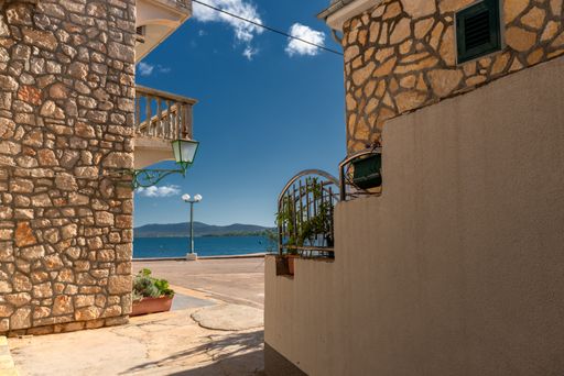 A beautiful view of small houses with potted plants by the sea