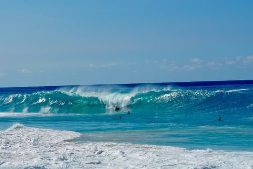 The surfer riding a wave in the ocean on a sunny day in  Kailua Kona Big Island in Hawaii