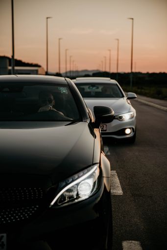 A beautiful shot of black and white cars driving in a highway