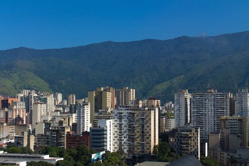 A beautiful view of tall buildings in Caracas, Venezuela with tall mountains in the background