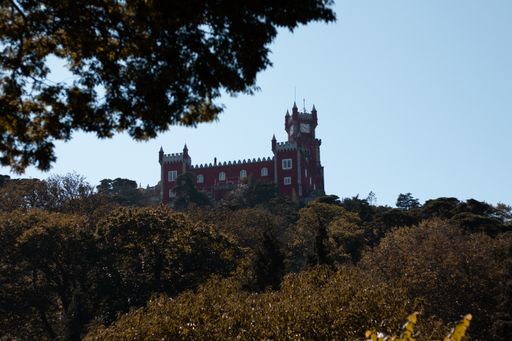 A low angle shot of Pena National Palace against blue sky on a sunny day in Sintra, Lisbon, Portugal