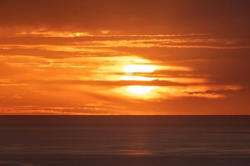 A mesmerizing scenery of a sunset at a sea